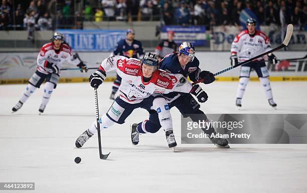 Jonah Miller of Berlin is challenged by Matt Smaby of EHC Muenchen during the DEL Ice Hockey match between EHC Muenchen and Eisbaeren Berlin on...