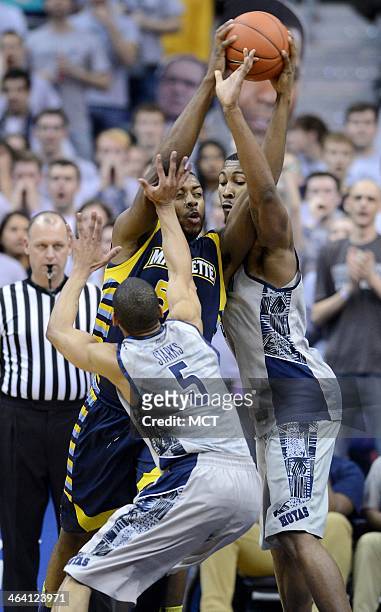 Marquette forward Davante Gardner battles with the ball against Georgetown forward Mikael Hopkins and Georgetown guard Markel Starks in the second...