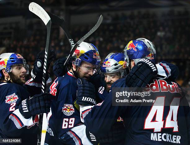 David Meckler of EHC Muenchen is congratualted by team mates after scoring a goal during the DEL Ice Hockey match between EHC Muenchen and Eisbaeren...