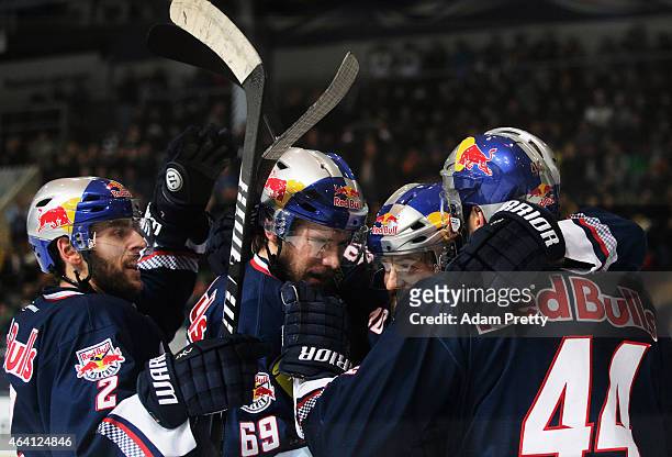 David Meckler of EHC Muenchen is congratualted by team mates after scoring a goal during the DEL Ice Hockey match between EHC Muenchen and Eisbaeren...
