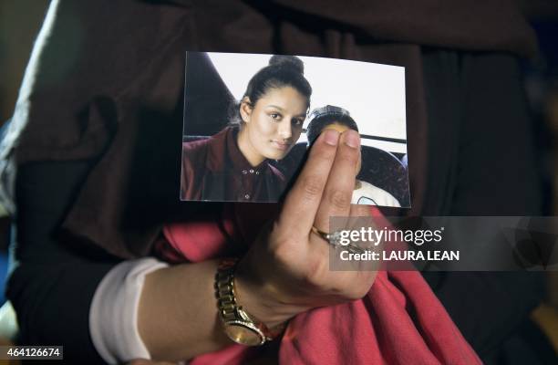 Renu, eldest sister of missing British girl Shamima Begum, holds a picture of her sister while being interviewed by the media in central London, on...