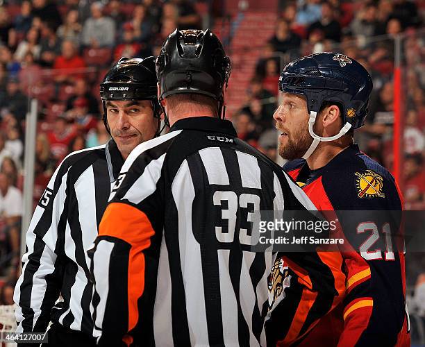 Linesmen Derek Amell and NHL Referee Kevin Pollock chat with Krys Barch of the Florida Panthers during a break in the action against the Montreal...