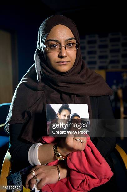 Renu Begum, eldest sister of Shamima Begum holds her sister's photo as she is interviewed by the media at New Scotland Yard, as the relatives of...