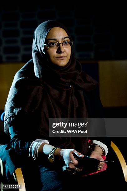 Renu, eldest sister of Shamima Begum holds her sister's pajamas and photos while being interviewed by the media at New Scotland Yard, as the...