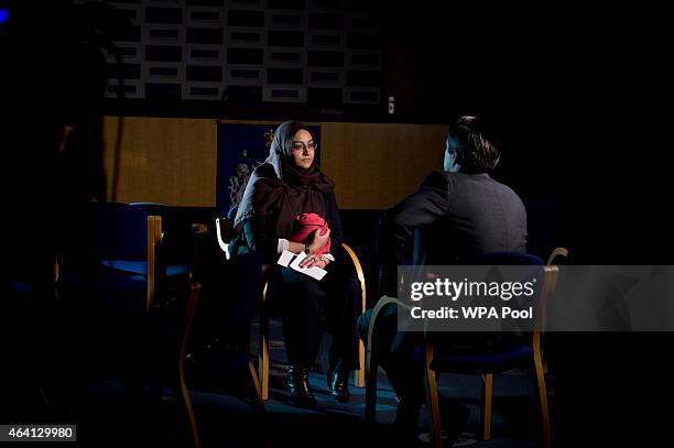 Renu, eldest sister of Shamima Begum holds her sister's pajamas and photos while being interviewed by the media at New Scotland Yard, as the...