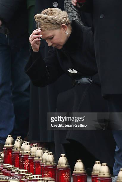 Ukrainian politician Yulia Tymoshenko crosses herself after laying a candle at ceremonies marking the first anniversary of the Maidan revolution that...
