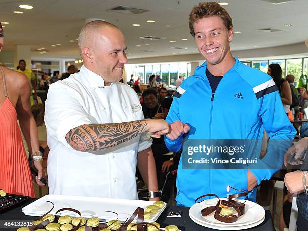 James Duckworth of Australia recieves a birthday macaron from pastry chef Pierrick Boyer in the Player Cafe during day 9 of the 2014 Australian Open...