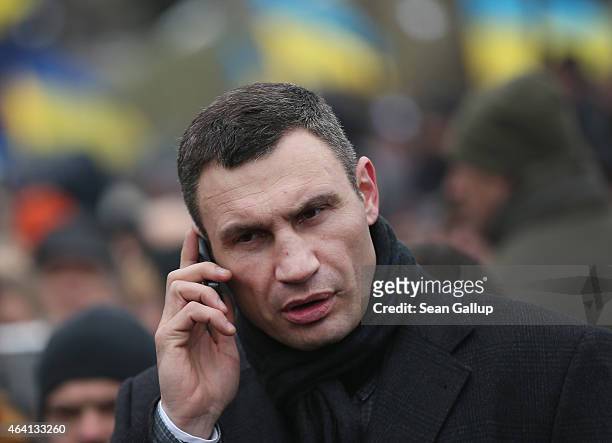 Kiev Mayor and former boxer Vitali Klitschko speaks on a mobile phone as he arrives to participate in the "March of Diginity" prior to ceremonies...