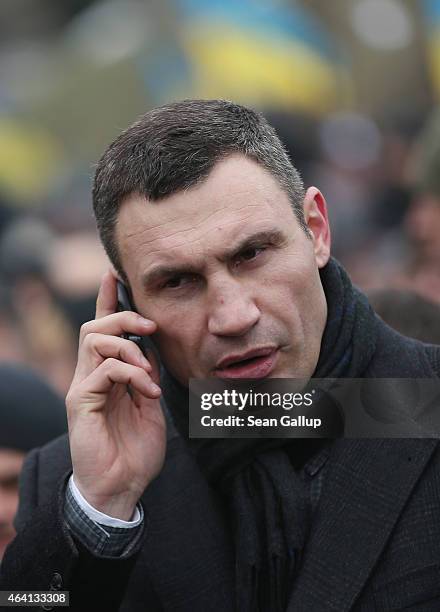 Kiev Mayor and former boxer Vitali Klitschko speaks on a mobile phone as he arrives to participate in the "March of Diginity" prior to ceremonies...