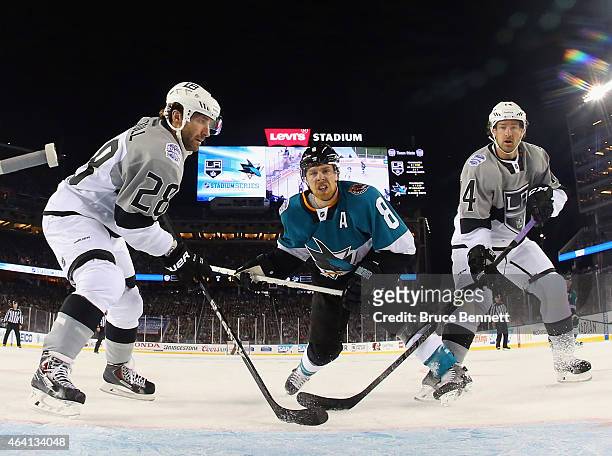 Joe Pavelski of the San Jose Sharks goes up against Jarret Stoll and Justin Williams of the Los Angeles Kings during the 2015 Coors Light NHL Stadium...