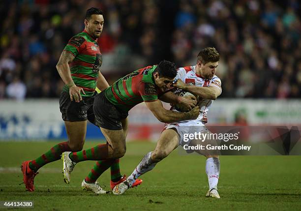 Tom Makinson of St Helens is tackled by Bryson Goodwin of South Sydney Rabbitohs during the World Club Challenge match between St Helens and South...