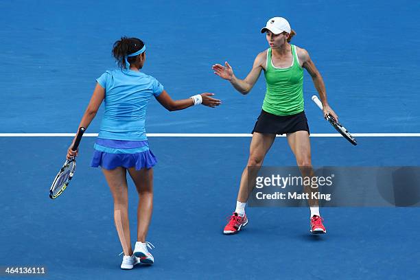 Sania Mirza of India and Cara Black of Zimbabwe in action in their fourth round doubles match against Sara Errani of Italy and Roberta Vinci of Italy...