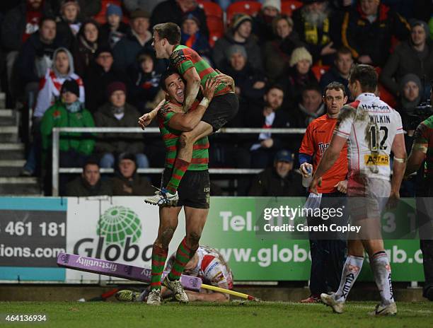 Joel Reddy of South Sydney Rabbitohs celebrates as he scores their seventh try with team mate Luke Keary as Jon Wilkin of St Helens looks on during...