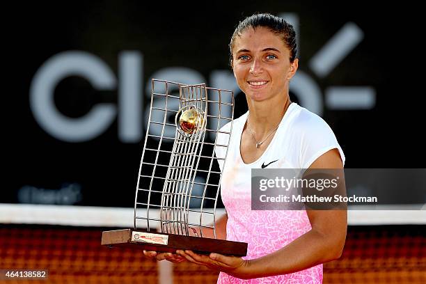 Sara Errani of Italy poses with the winner's trophy after defeating Anna Schmiedlova of Slovakia during the final of the Rio Open at the Jockey Club...