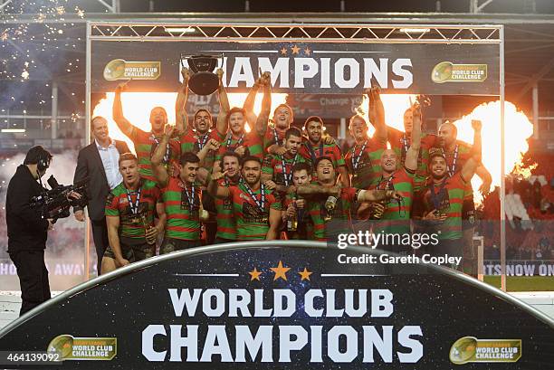 Captain Greg Inglis of South Sydney Rabbitohs lifts trophy in celebration alongside team mates after the World Club Challenge match between St Helens...