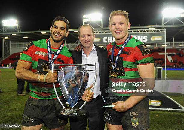 Captain Greg Inglis, Michael Maguire head coach of South Sydney Rabbitohs and George Burgess celebrate with the trophy after victory in the World...