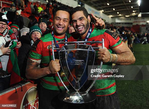 Captain Greg Inglis and John Sutton of South Sydney Rabbitohs of South Sydney Rabbitohs celebrate with the trophy after victory in the World Club...