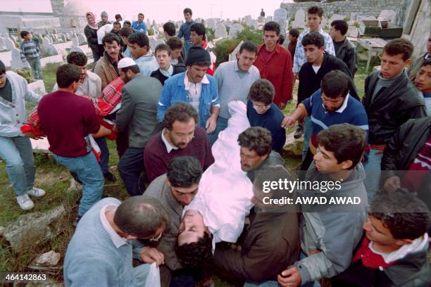 Palestinians carry the bodies of dead worshippers to their burial place in Abu Tor, East Jerusalem on February 25 after the Cave of the Patriarchs...