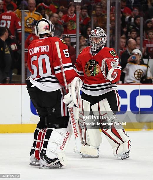 Corey Crawford of the Chicago Blackhawks is replaced in the second period by Antti Raanta against the Boston Bruins at the United Center on February...