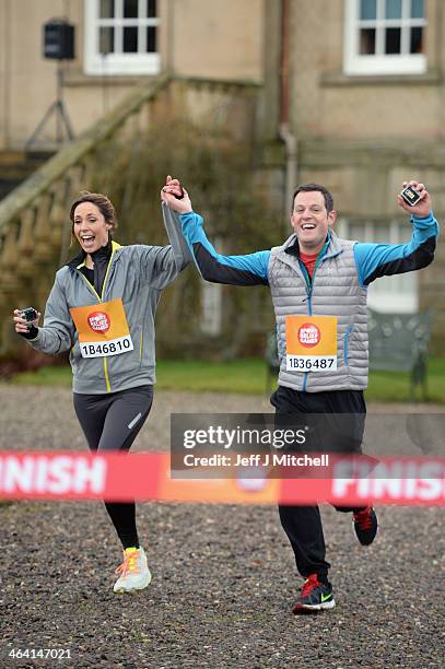 Alex Jones and Mark Baker from The One Show cross the finish line during The Dumfries House Sport Relief Mile officially started by Prince Charles on...