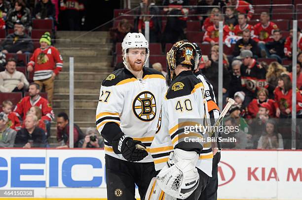 Dougie Hamilton and goalie Tuukka Rask of the Boston Bruins celebrate after defeating the Chicago Blackhawks 6-2 during the NHL game at the United...