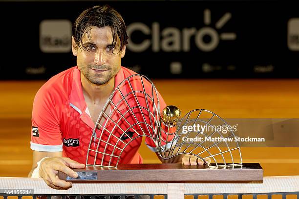 David Ferrer of Spain poses for photographers after his win over Fabio Fognini of Italy during the final of the Rio Open at the Jockey Club...
