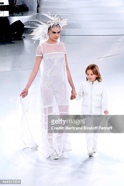 Model Cara Delevingne and godson of Karl Lagerfeld, Hudson Kroenig walk the runway during the Chanel show as part of Paris Fashion Week Haute-Couture...