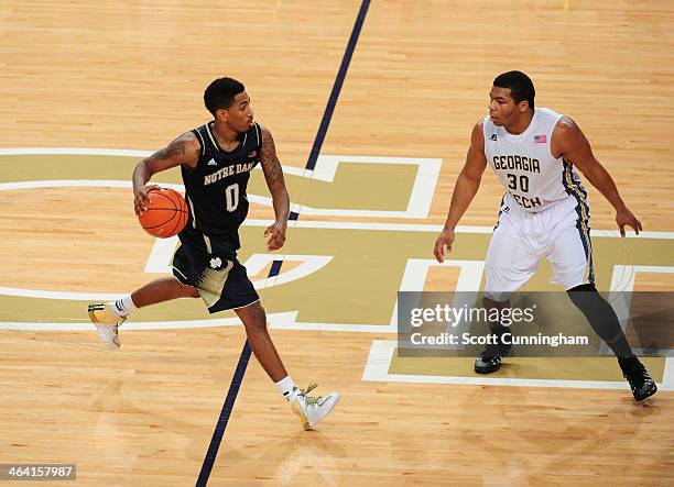 Eric Atkins of the Notre Dame Fighting Irish drives against Corey Heyward of the Georgia Tech Yellow Jackets at McCamish Pavilion on January 11, 2014...