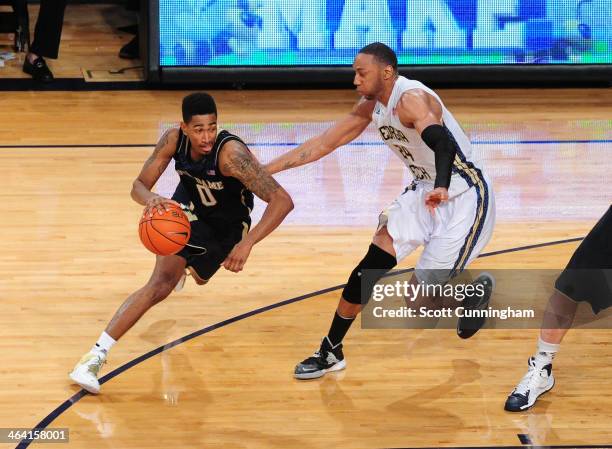 Eric Atkins of the Notre Dame Fighting Irish drives against Kammeon Holsey of the Georgia Tech Yellow Jackets at McCamish Pavilion on January 11,...