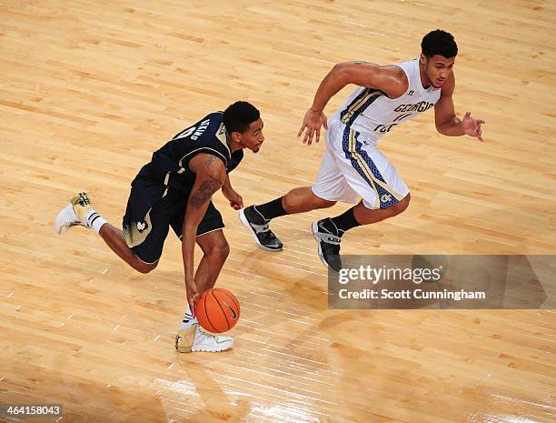 Eric Atkins of the Notre Dame Fighting Irish drives against Chris Bolden of the Georgia Tech Yellow Jackets at McCamish Pavilion on January 11, 2014...