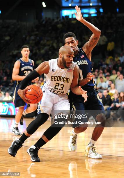 Trae Golden of the Georgia Tech Yellow Jackets drives against Eric Atkins of the Notre Dame Fighting Irish at McCamish Pavilion on January 11, 2014...