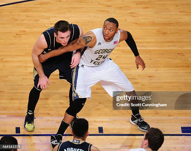 Kammeon Holsey of the Georgia Tech Yellow Jackets boxes out against Pat Connaughton of the Notre Dame Fighting Irish at McCamish Pavilion on January...