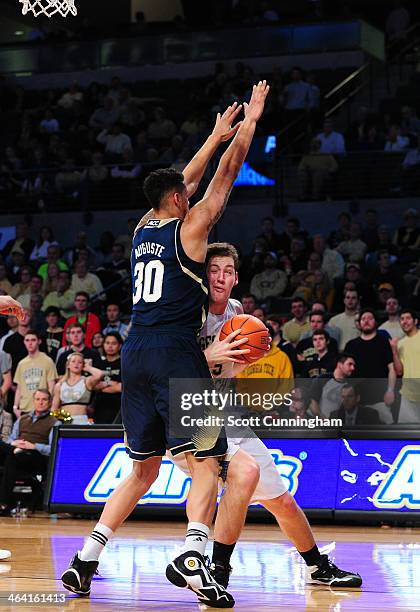 Daniel Miller of the Georgia Tech Yellow Jackets drives against Zach Auguste of the Notre Dame Fighting Irish at McCamish Pavilion on January 11,...