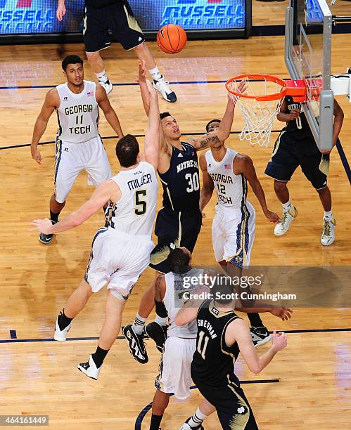 Zach Auguste of the Notre Dame Fighting Irish goes up for a rebound against Daniel Miller of the Georgia Tech Yellow Jackets at McCamish Pavilion on...