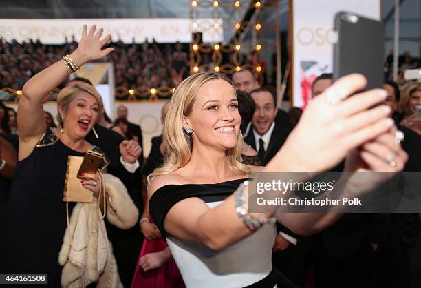 Actress Reese Witherspoon takes a selfie at the 87th Annual Academy Awards at Hollywood & Highland Center on February 22, 2015 in Hollywood,...