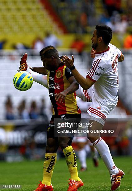 Jonathan Gonzales of Leones Negros vies for the ball with Jesus Chavez of Tijuana during their Mexican Clausura 2015 tournament football match at...