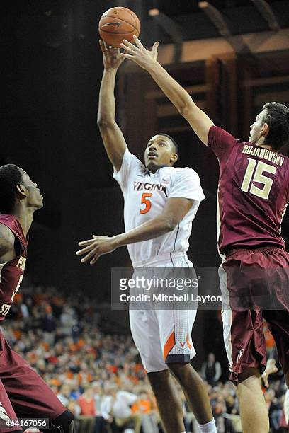 Darion Atkins of the Virginia Cavaliers takes a shot over Boris Bojanovsky of the Florida State Seminoles during a college basketball game at John...