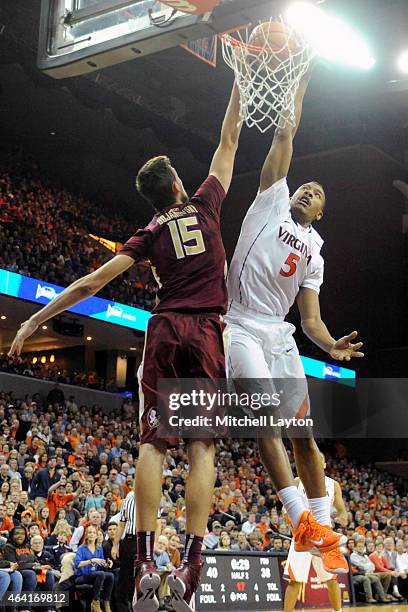 Darion Atkins of the Virginia Cavaliers takes a shot over Boris Bojanovsky of the Florida State Seminoles during a college basketball game at John...