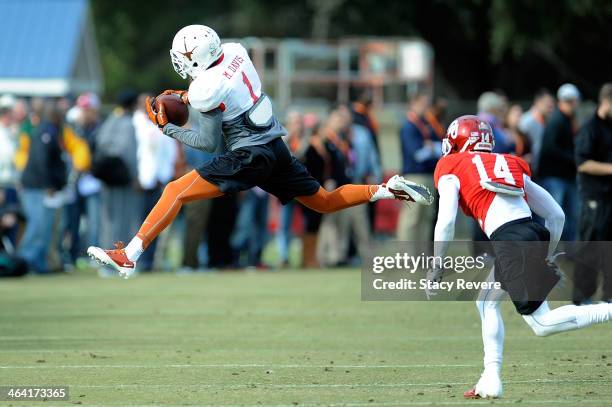 Mike Davis of the South team catches a pass in front of Aaron Colvin during a Senior Bowl practice session at Fairhope Stadium on January 20, 2014 in...