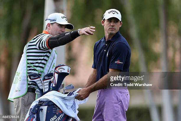 Jonathan Byrd discusses a tee shot on the second hole with his caddy during the final round of the Humana Challenge in partnership with the Clinton...