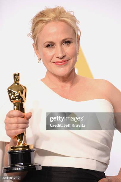 Actress Patricia Arquette, with the award for best actress in a supporting role for "Boyhood", poses in the press room during the 87th Annual Academy...