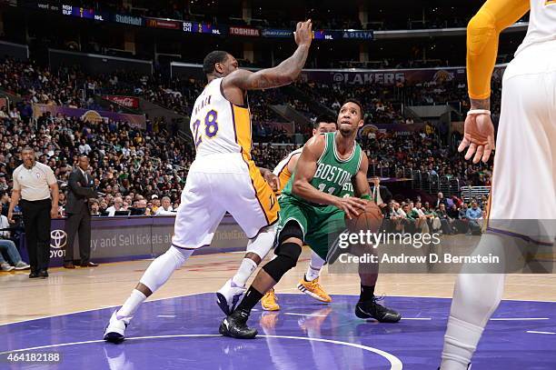 Evan Turner of the Boston Celtics handles the ball against Tarik Black of the Los Angeles Lakers on February 22, 2015 at Staples Center in Los...