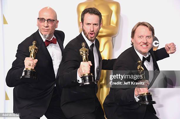 Roy Conli, Chris Williams and Don Hall, with the award for best animated feature film for "Big Hero 6", pose in the press room during the 87th Annual...