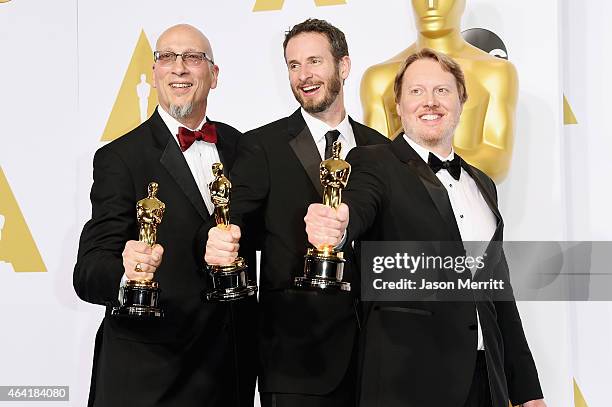 Chris Williams, Roy Conli, and Don Hall, winners of the Best Animated Feature Award for 'Big Hero 6', pose in the press room during the 87th Annual...