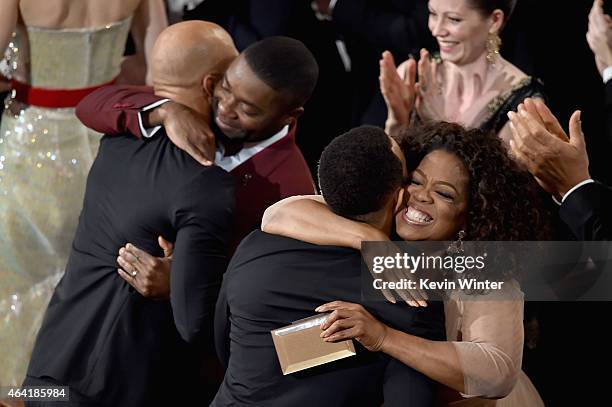 Lonnie Lynn aka Common hugs actor David Oyelowo and John Stephens aka John Legend hugs Oprah Winfrey after winning the Best Original Song Award for...