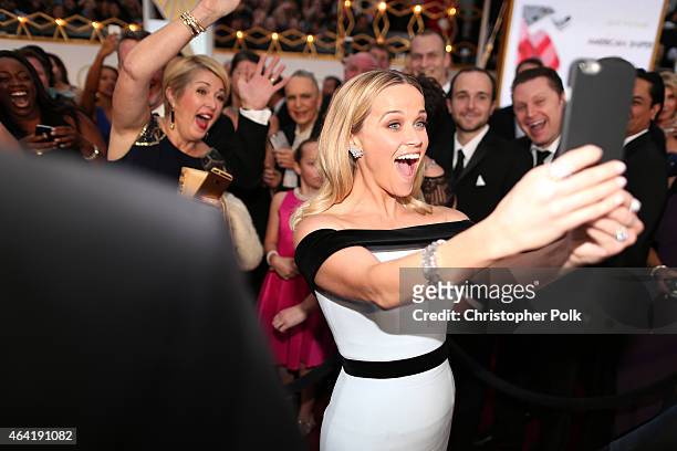 Actress Reese Witherspoon takes a selfie while attending the 87th Annual Academy Awards at Hollywood & Highland Center on February 22, 2015 in...