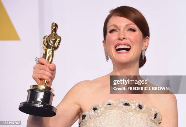 Actress Julianne Moore, winner for the Best Actress in a Leading Role Award for "Still Alice" poses in the press room during the 87th Oscars on...