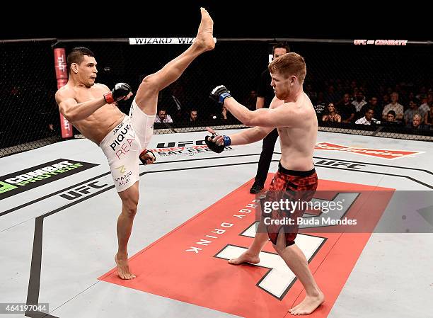 Cezar Ferreira of Brazil kicks Sam Alvey of the United States in their middleweight bout during the UFC Fight Night at Gigantinho Gymnasium on...