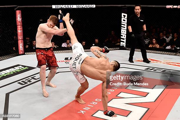 Cezar Ferreira of Brazil kicks Sam Alvey of the United States in their middleweight bout during the UFC Fight Night at Gigantinho Gymnasium on...