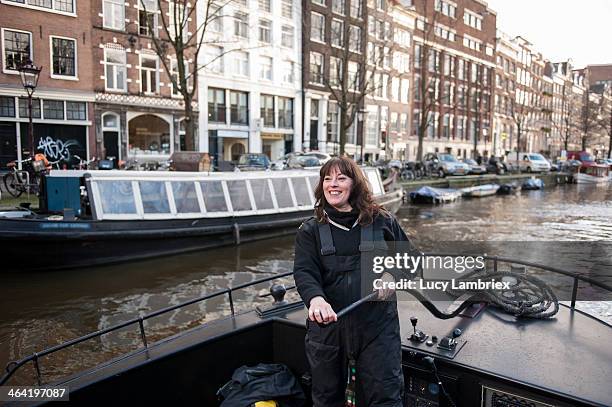 female captain at the helm - narrow boat stock pictures, royalty-free photos & images